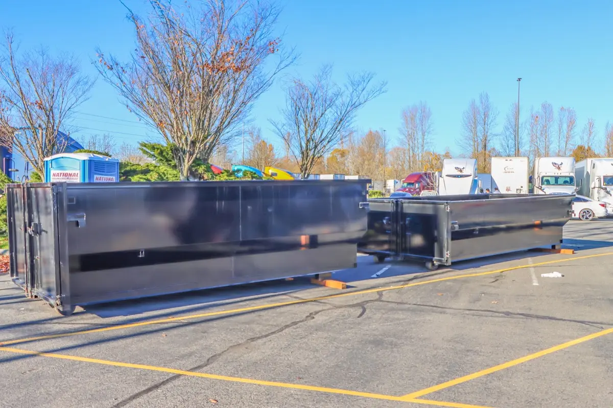 Professional dumpster rental service with roll-off container on residential driveway in South Orange Village